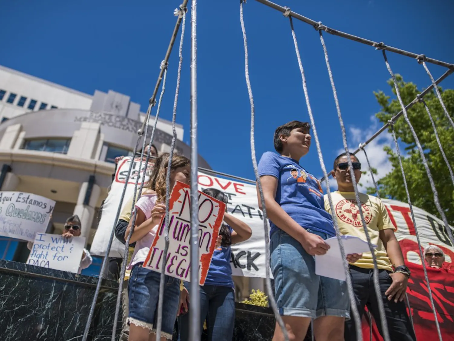 Gabriela Hernandez, center, stands with others in a replicated immigrant detention cell in front of the Metropolitan Courthouse Monday, May 1, 2017. The event was a series of public demonstrations centered around May Day and immigrant and workers rights in the United States. 