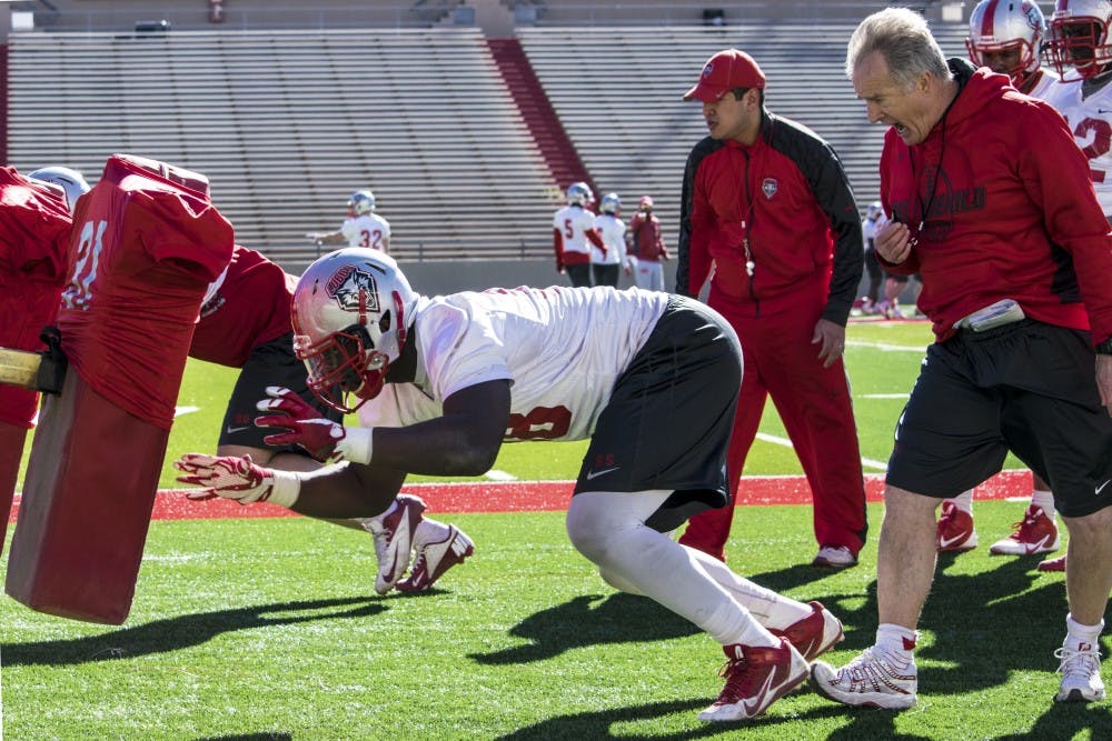 Defensive Line Coach Barry Sacks helps sophomore defensive lineman Kene Okonkwo on Wednesday morning’s drill practice.  This was the second practice held in preparation for the 2016 football season.