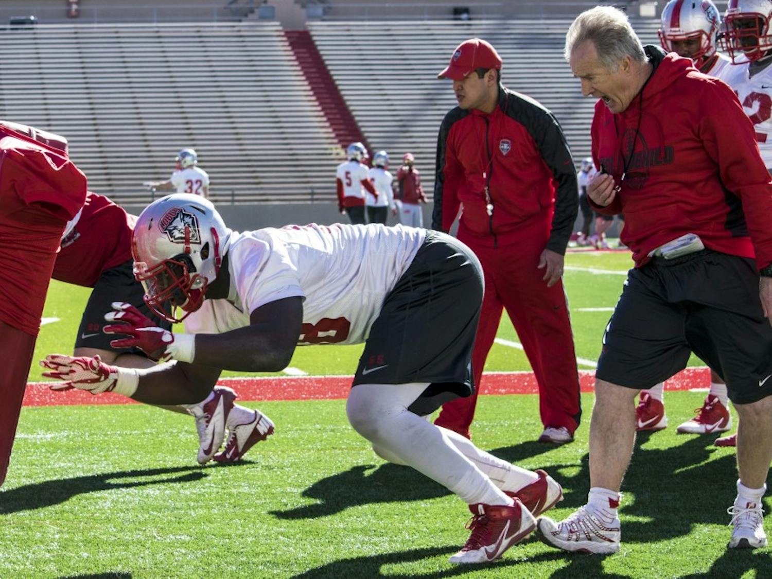 Defensive Line Coach Barry Sacks helps sophomore defensive lineman Kene Okonkwo on Wednesday morning’s drill practice. This was the second practice held in preparation for the 2016 football season.