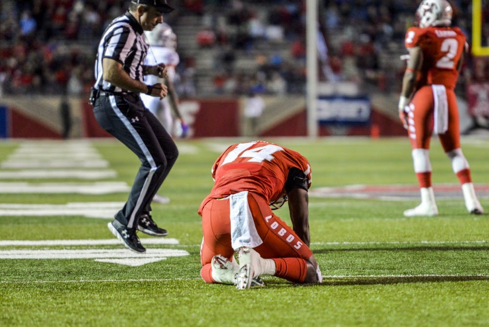 Redshirt senior safety Daniel Henry kneels after a failed interception attempt against Boise State on Friday, Oct. 7, 2016 at University Stadium.&nbsp;
