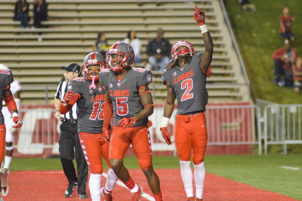 Senior wide receiver Dameon Gamblin, 2, celebrates with teammates after scoring in the Lobo end zone at University Stadium on Saturday, Oct. 22, 2016.