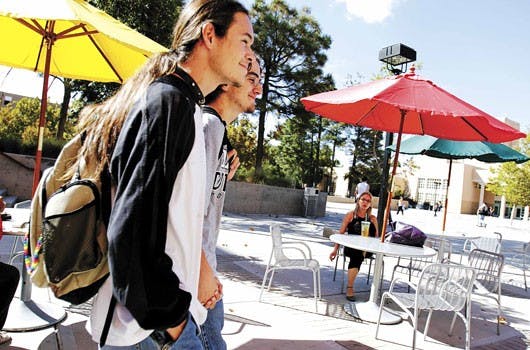Students David Martinez, left, and David Gonzalez hold hands while walking to the SUB on Oct. 3. Gonzalez says they have no problem showing affection in public, but they are still growing accustomed to the mixed reactions they have received during the mon