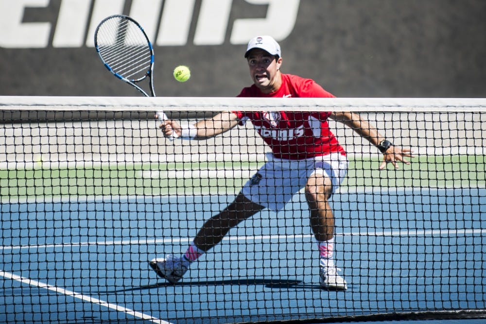 Redshirt junior Rodolfo Jauregui rushes down to the net to return the ball to a Boise State player Sunday afternoon at the McKinnon Family Tennis Stadium.