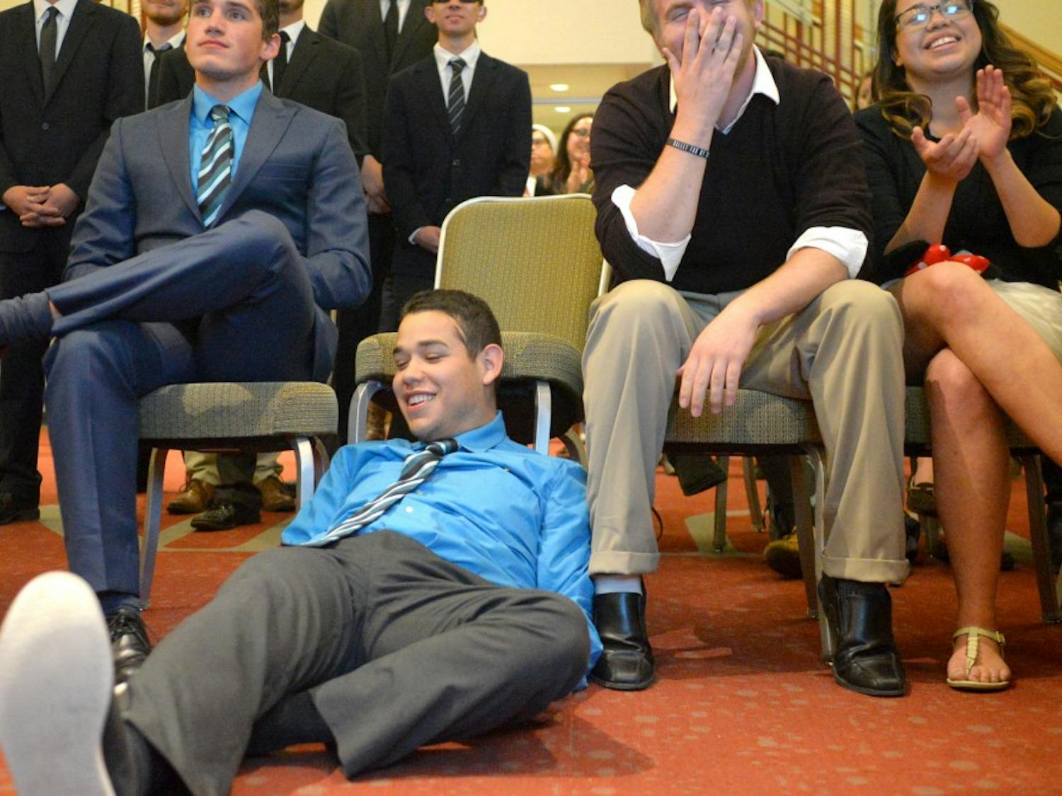 Jorge Guerrero falls out of his chair upon hearing he is reelected to the ASUNM Senate.