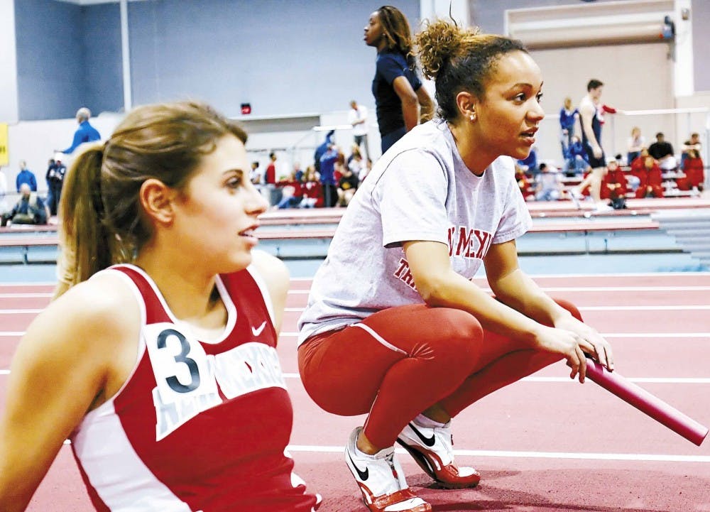 Runner Ariel Burr, right, talks to Christina Zarrella before the women's 4x400 meter relay at the TCR Invitational on Saturday at the Albuquerque Convention Center.  