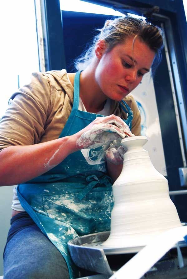 Margo Murray throws porcelain in Masley Hall on Tuesday.