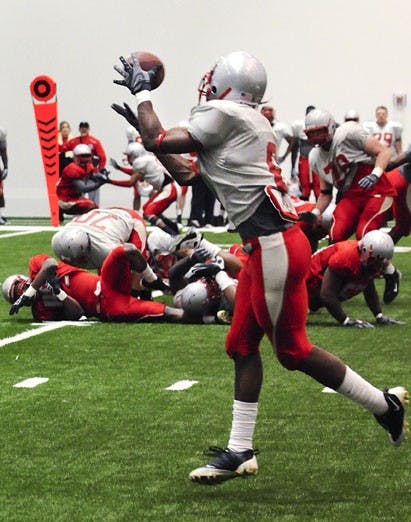 Roland Bruno snags a pass during Saturday's scrimmage at the Indoor Practice Facility. UNM's wide receivers will carry more of the load in offensive coordinator Darrell Dickey's scheme than they did last year. Last year, the Lobos' receivers had three tou