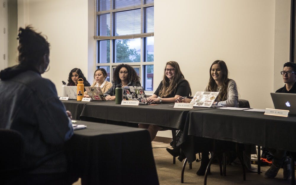 Members of the ASUNM Finance Committee laugh during discussion regarding an appropriation for student group Lobo Slam.