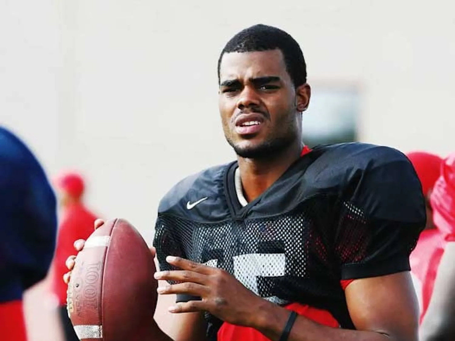 UNM quarterback Donovan Porterie warms up on the sidelines before practice.
