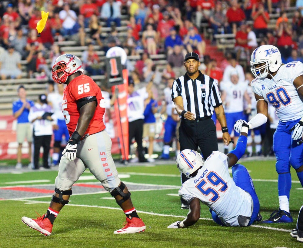 New Mexico offensive lineman Aaron Jenkons  walks away from a play after the referee throws a penalty flag against the Lobos. UNM had 14 penalties for 154 yards during its 21-40 loss against the Golden Hurricane. 