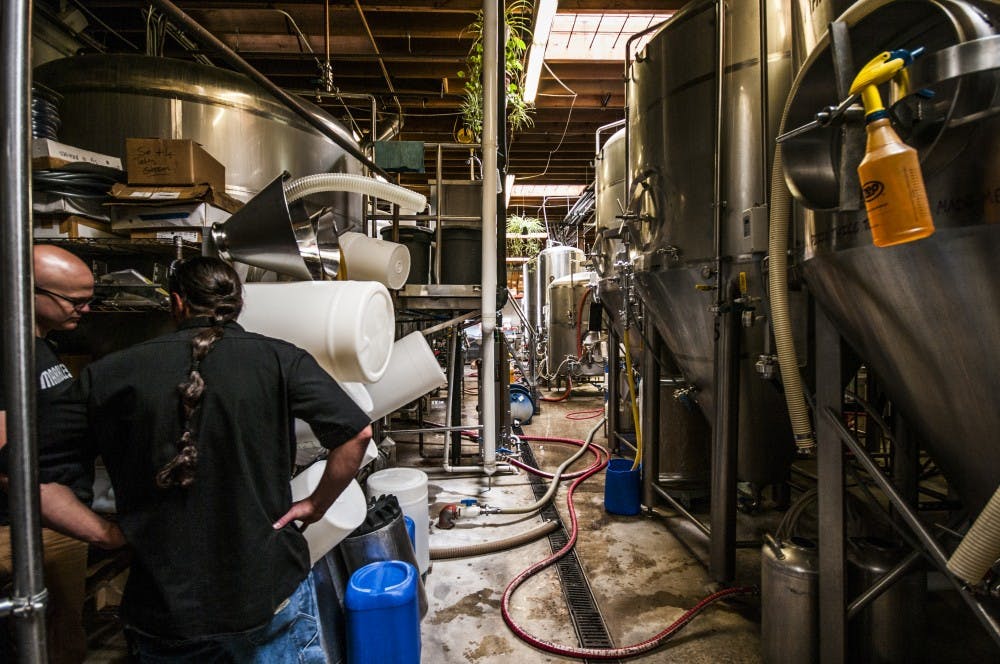 Marble Brewery's head brewer, Josh Trujillo, makes his rounds threw the brewery where he and others craft all of Marble's beers. Beers such as these could potentially be sold in the newly proposed taproom on UNM's main campus.&nbsp;