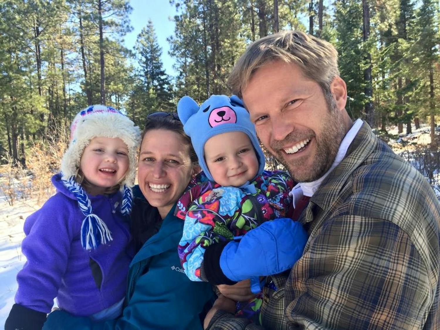 Mayor Tim Keller smiles with his wife, Elizabeth Keller, and their children, Maya and Jack.