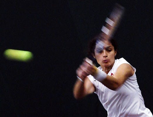 Ola Abou-Zekry whacks a ball during a match against Northern Arizona at the UNM Tennis Complex on Sunday. 