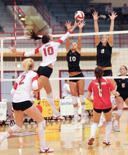 Jeanne Fairchild leaps to spike a ball in Saturday's match against San Diego State. Fairchild pitched in 15 kills, and the Lobos swept the Aztecs 3-0. 