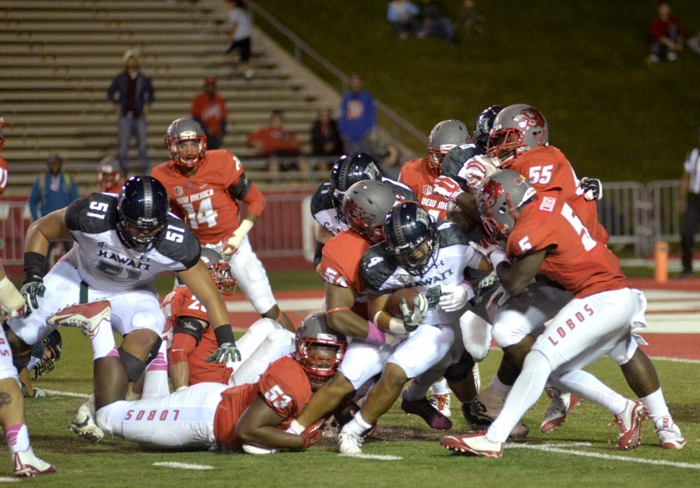 UNM's defensive line holds back junior running back Steven Lakalaka at University Stadium Oct.17, 2015. The Lobos beat the Rainbow Warriors 28-27. 