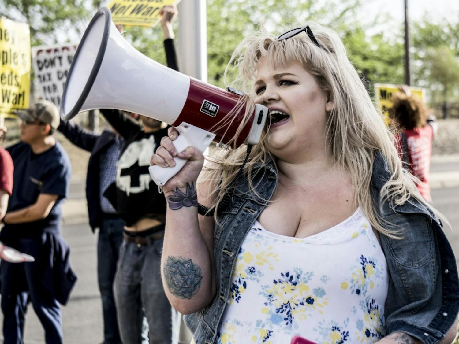 A protest organizer against the war in Syria leads a chant on a megaphone on the corner of Girard and San Mateo on Thursday, April 12, 2018. &nbsp;