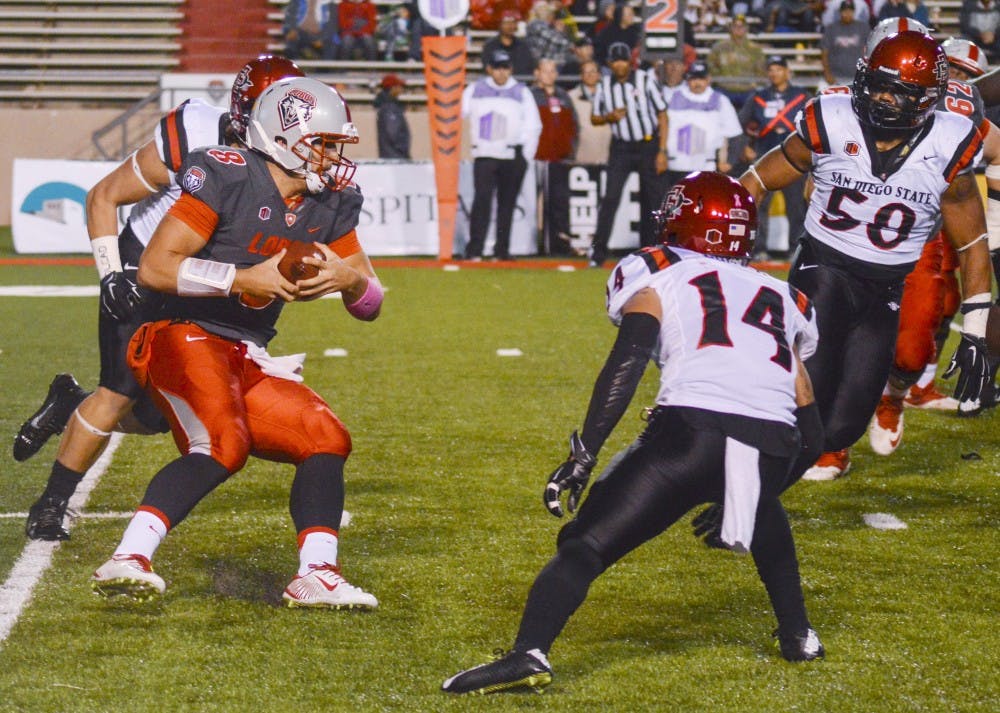 UNM quarterback Cole Gautsche (8) attempts to rush past the San Diego State Aztecs at University Stadium on Friday, Oct. 10. Gautsche and Lamar Jordan, another Lobo quarterback, have spent the last three games splitting playing time on the field.