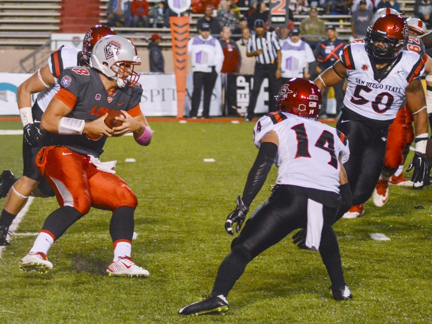 UNM quarterback Cole Gautsche (8) attempts to rush past the San Diego State Aztecs at University Stadium on Friday, Oct. 10. Gautsche and Lamar Jordan, another Lobo quarterback, have spent the last three games splitting playing time on the field.