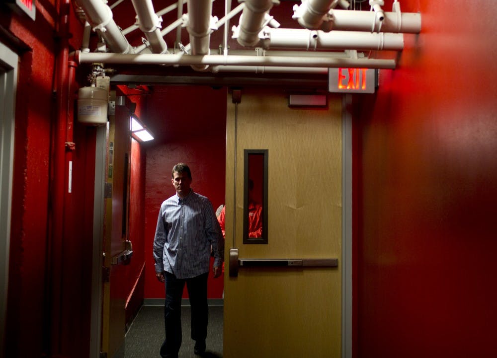 	Men’s basketball coach Steve Alford walks toward the media work area for a Saturday press conference at The Pit announcing his decision to accept the same position at UCLA. Alford coached the Lobos for six years.