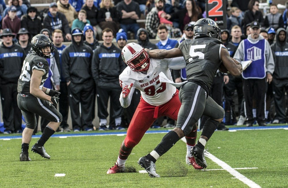 Nahje Flowers wraps up Air Force quarterback DJ Hammond III for a sack during the second quarter of Saturday’s game at Falcon Field on the campus of the U.S. Air Force Academy in Colorado. The Lobos lost 42-24.