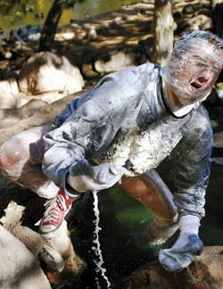 Student Sean Ward, dressed as an albino from the future for Halloween, cools off in the Duck Pond during a break between classes Tuesday.