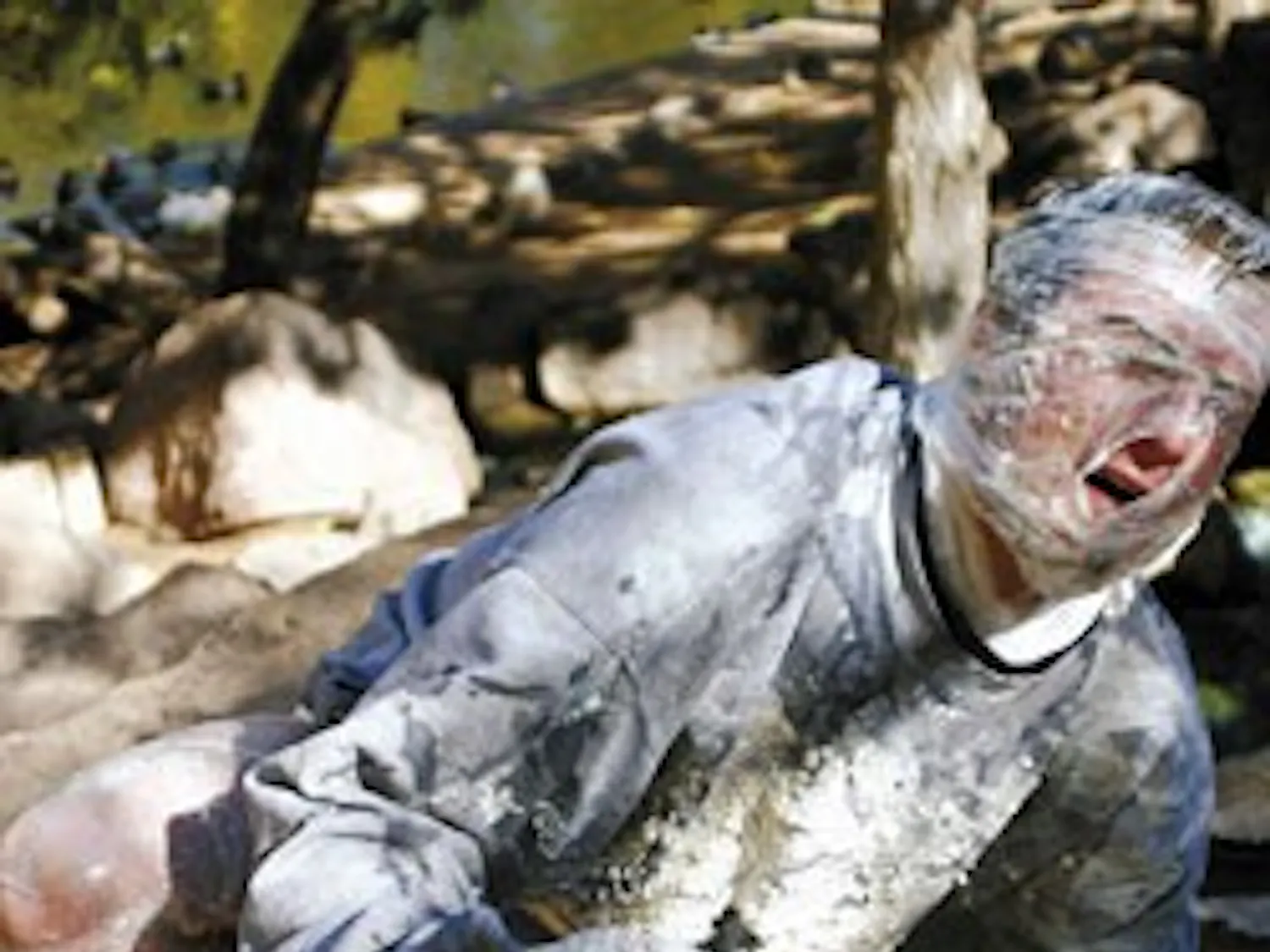 Student Sean Ward, dressed as an albino from the future for Halloween, cools off in the Duck Pond during a break between classes Tuesday.