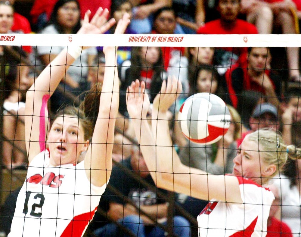	UNM’s Taylor Hadfield and Lexi Ross attempt a block on Sunday’s game at Johnson Center against UC-Santa Barbara. The Lobos lost after five sets.