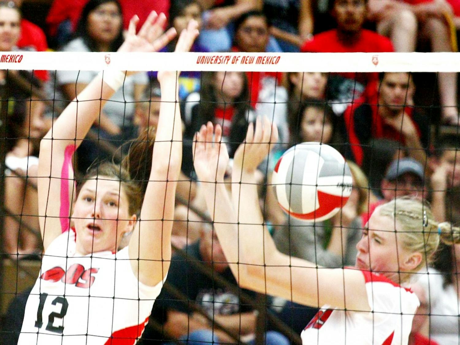 	UNM’s Taylor Hadfield and Lexi Ross attempt a block on Sunday’s game at Johnson Center against UC-Santa Barbara. The Lobos lost after five sets.