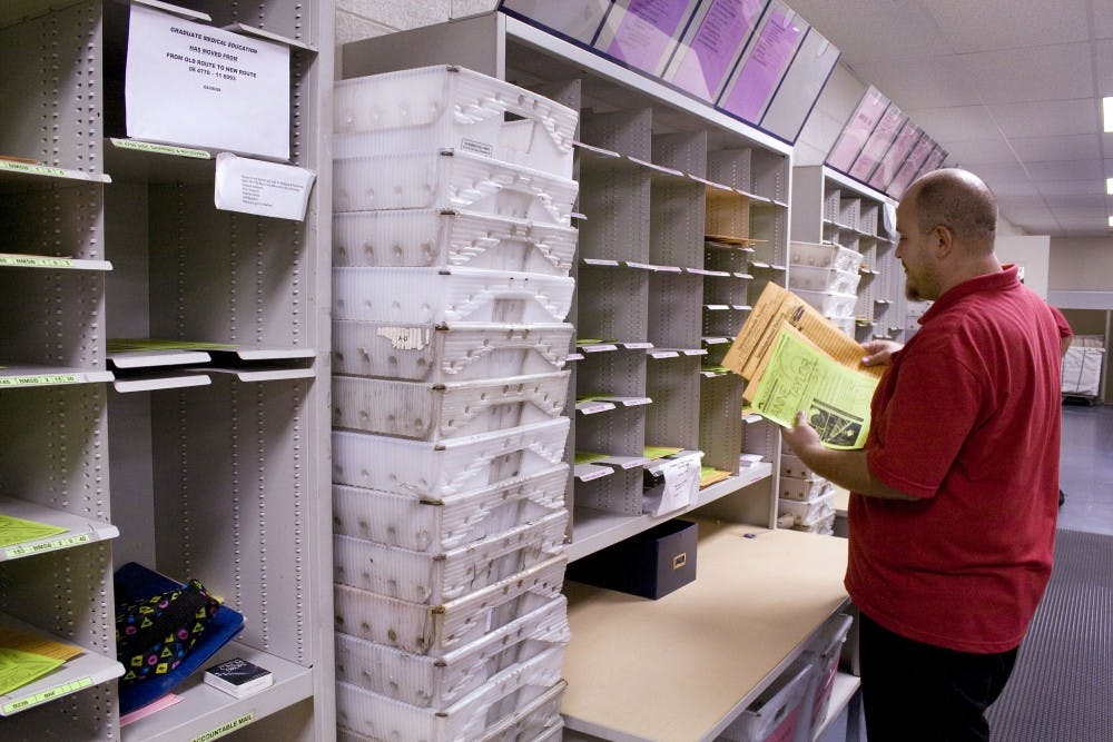 	UNM Mail Tech John Barberi sorts mail Wednesday at UNM Mail Systems. UNM policy states that no personal mail can be delivered to a University address. 