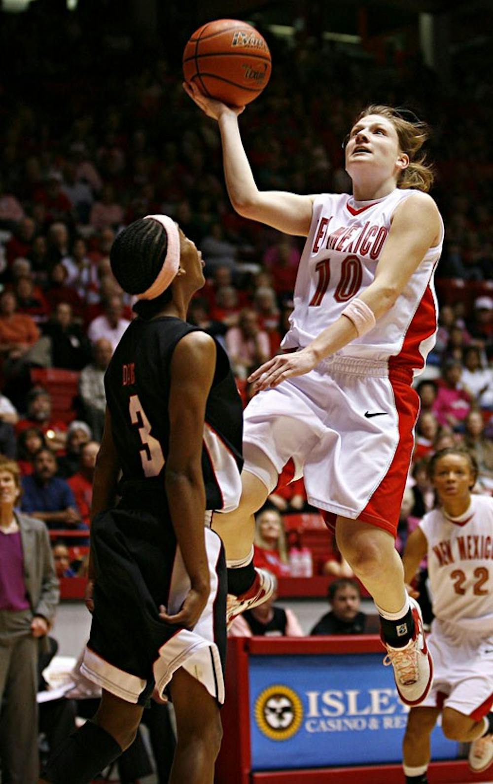 UNM guard Amy Beggin shoots a basket over San Diego State's Quenese Davis during Wednesday's game at The Pit. 