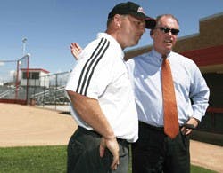 UNM athletic director Paul Krebs, right, welcomes newly-hired softball coach Ty Singleton during an address to the media at Lobo Field on Tuesday.