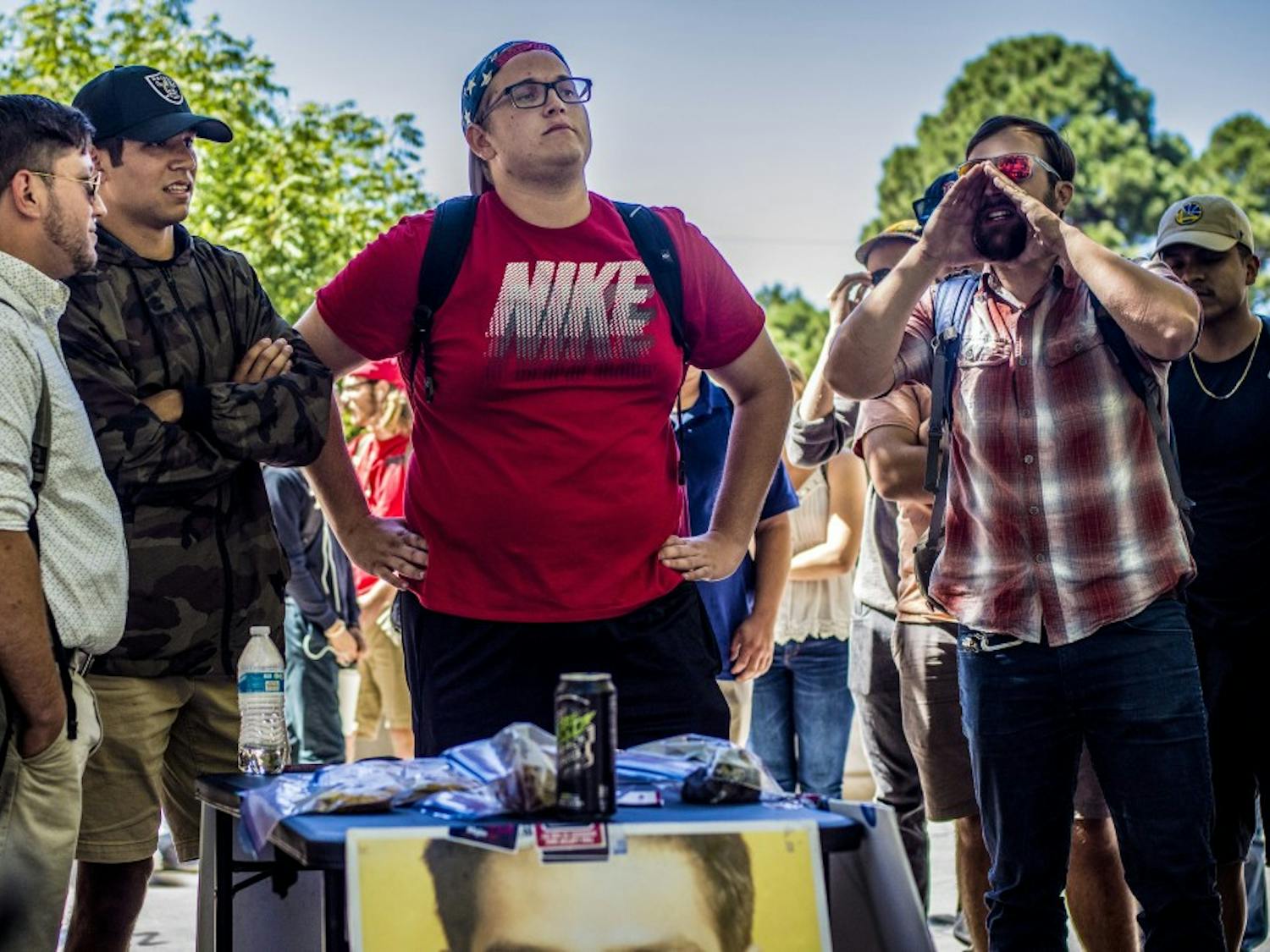 Walter Baker, graduate student, right, shouts in contention to an "Affirmative Action Bake Sale" hosted by a local chapter of Turning Point USA outside the student union building, Thursday, September 21, 2017. The student group hosted the bake sale which charged patrons according to their ethnicity.