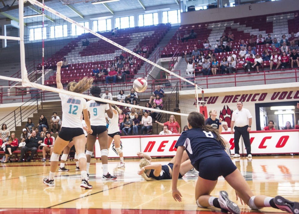 Cassie House, #12 and Simone Henderson, #9, celebrate after a successful play during their game against Nevada Saturday Sept. 27, 2015. The Lobos went on to beat Nevada 3-1.