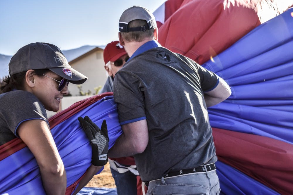 Balloon chase crew members for the Flying Monkeys begin to disassemble their hot air balloon, High Maintenance II.