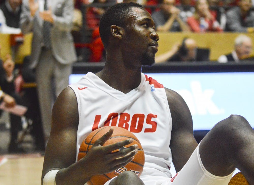 Lobo junior center J.J. Nâ€™Ganga sits on the court after falling backward during the game against USC at the Pit on Sunday afternoon. The Lobos lost to USC 66-54.
