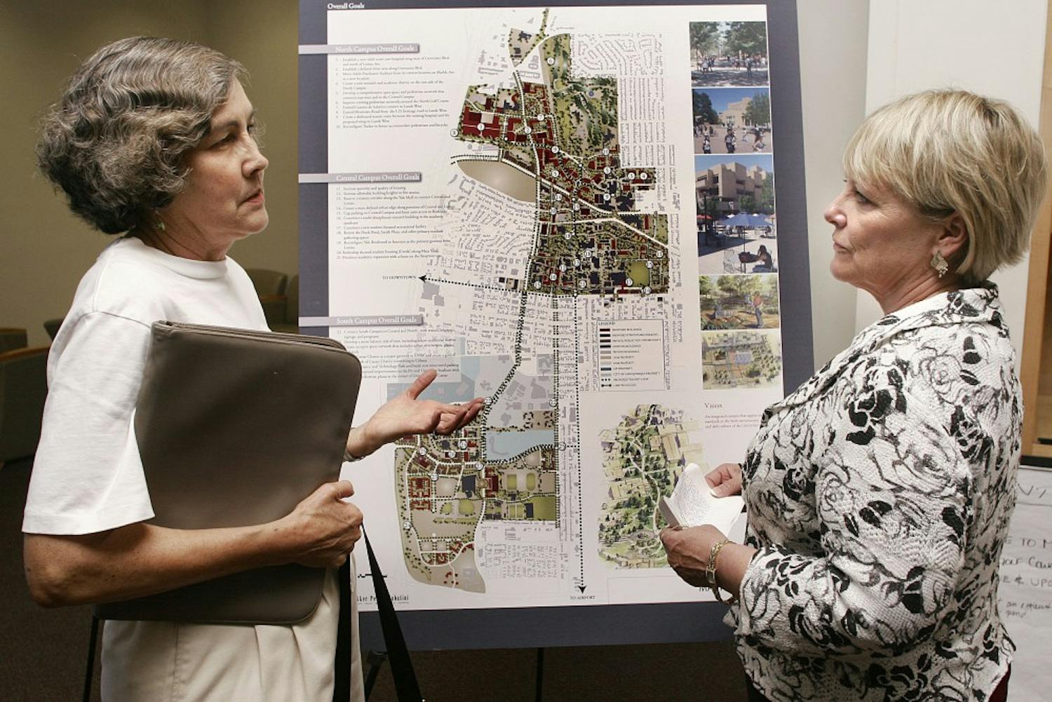 	Professor Merideth Paxton, left, asks University Planning Officer Mary Kenney about the impact of the UNM Master Plan of development on surrounding neighborhoods. The Office of Institutional Support Services hosted two open houses in the SUB on Monday seeking input. 