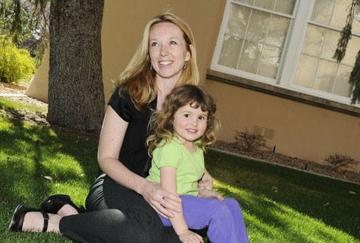 Lissa Knudsen sits with her daughter, Emily, outside Zimmerman Library.