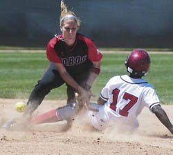 UNM second basemen Kristina Schmallen drops the ball while San Diego outfielder Tamani Wells slides safe to second during the first game of a doubleheader Saturday at Lobo Field.  
