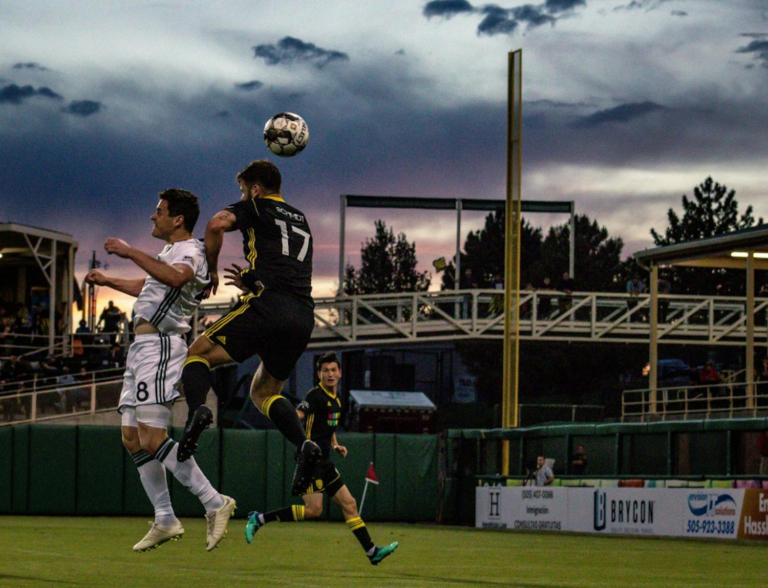 New Mexico United headbutting at sunset