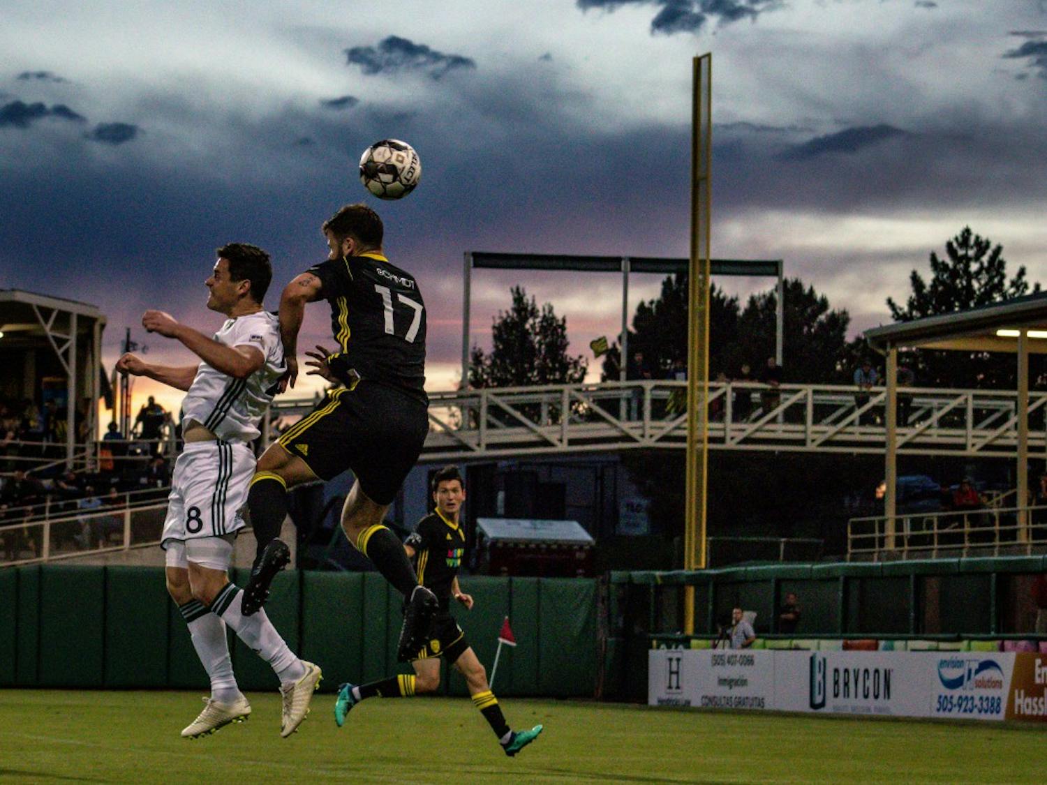 New Mexico United headbutting at sunset