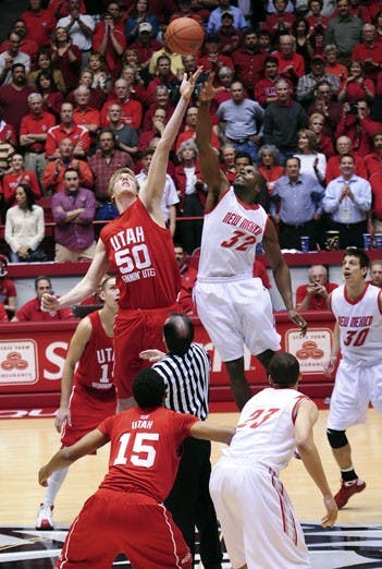 Tony Danridge and Luke Nevill sky for the ball in Tuesday's opening tip. After defeating the Utes 77-71, the Lobos are in a three-way tie for first place in the MWC. UNM will look to finish the season with a victory at Wyoming on Saturday.