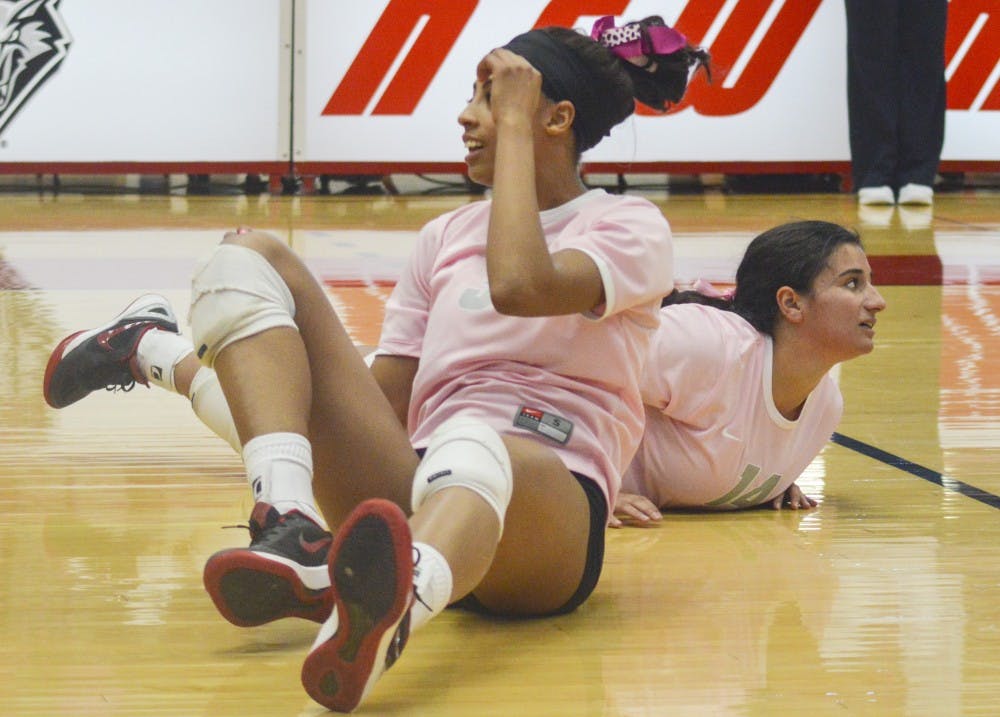 Lobo redshirt senior right-side hitter Chantale Riddle (3) and freshman defensive specialist Stephanie Chavez (14) recover after both players fail to keep the ball in play during the game against Wyoming at Johnson Gym on Saturday afternoon. The Lobos lost to Wyoming 1-3, winning only one set of four.