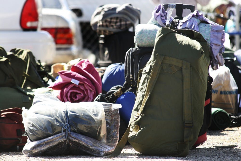 	Homeless veterans set down their bags and blankets before getting aid from the Veterans Integration Center event “Stand Down and Project Hand Up” on Monday. The event offered assistance to more than 400 veterans.