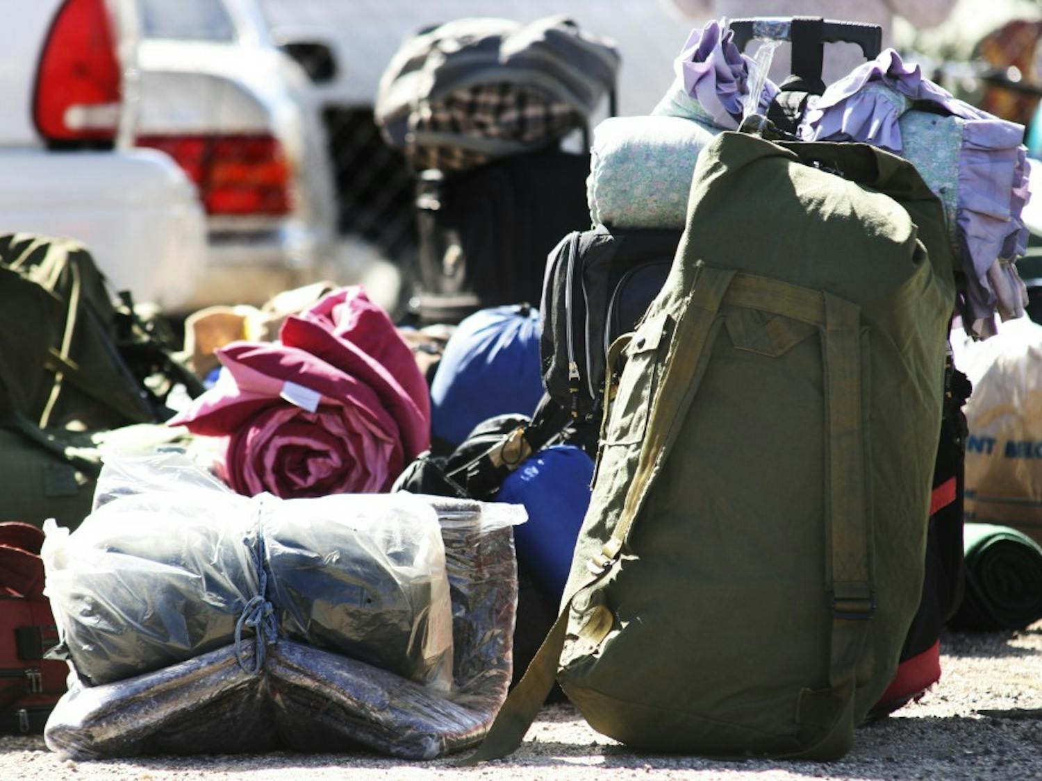 	Homeless veterans set down their bags and blankets before getting aid from the Veterans Integration Center event “Stand Down and Project Hand Up” on Monday. The event offered assistance to more than 400 veterans.