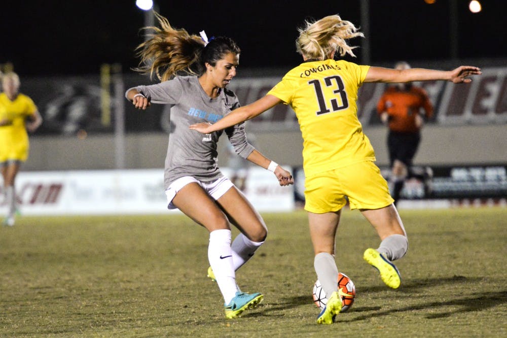 Sophomore midfielder Jennifer Munoz charges a Wyoming player during their game at University Stadium Friday, Oct. 21, 2016. The Lobos defeated San Diego State in their last conference game 2-1.