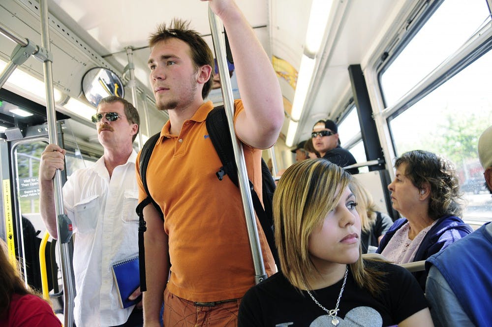 	Students Dylan Coonce, center and Samantha Lujan, right, crowd into the ABQRide line that runs from Yale Boulevard to Downtown on Wednesday. Roughly 1 million passengers used the
service in March.