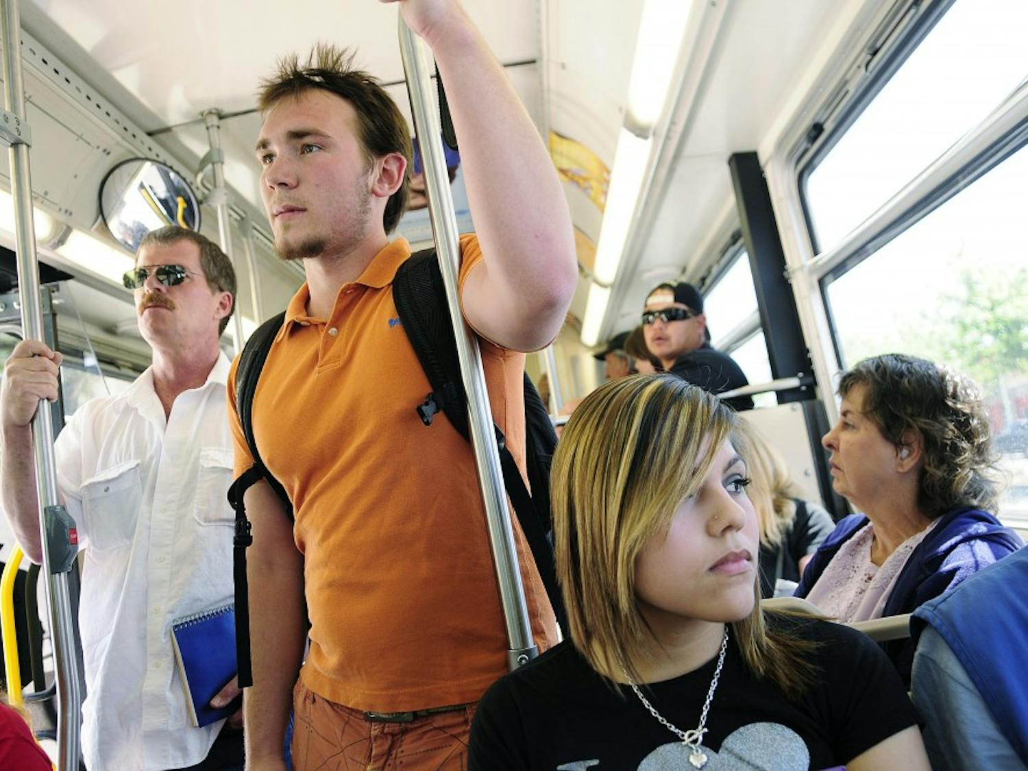 Students Dylan Coonce, center and Samantha Lujan, right, crowd into the ABQRide line that runs from Yale Boulevard to Downtown on Wednesday. Roughly 1 million passengers used the
service in March.