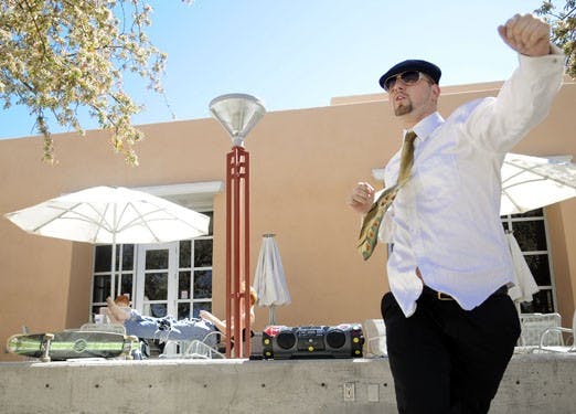 Student Joshua Arellano dances to house music from his boom box outside the SUB on Thursday. "House is about love," he said.