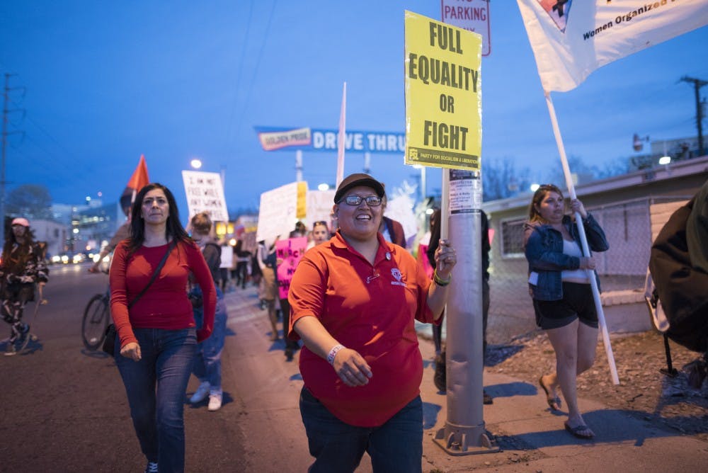 Female protestors march along Lomas Boulevard during National Women's Day on Wednesday, March 8, 2017 in Albuquerque, New Mexico. WalletHub has ranked New Mexico as the ninth worst state in the country for women.