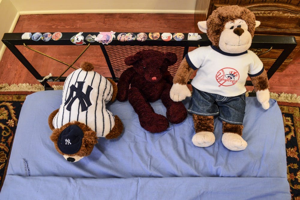 Stuffed bears line the edge of a bead in the House ≠ Home, Ariane Crummer's BFA Honors Thesis Exhibition.